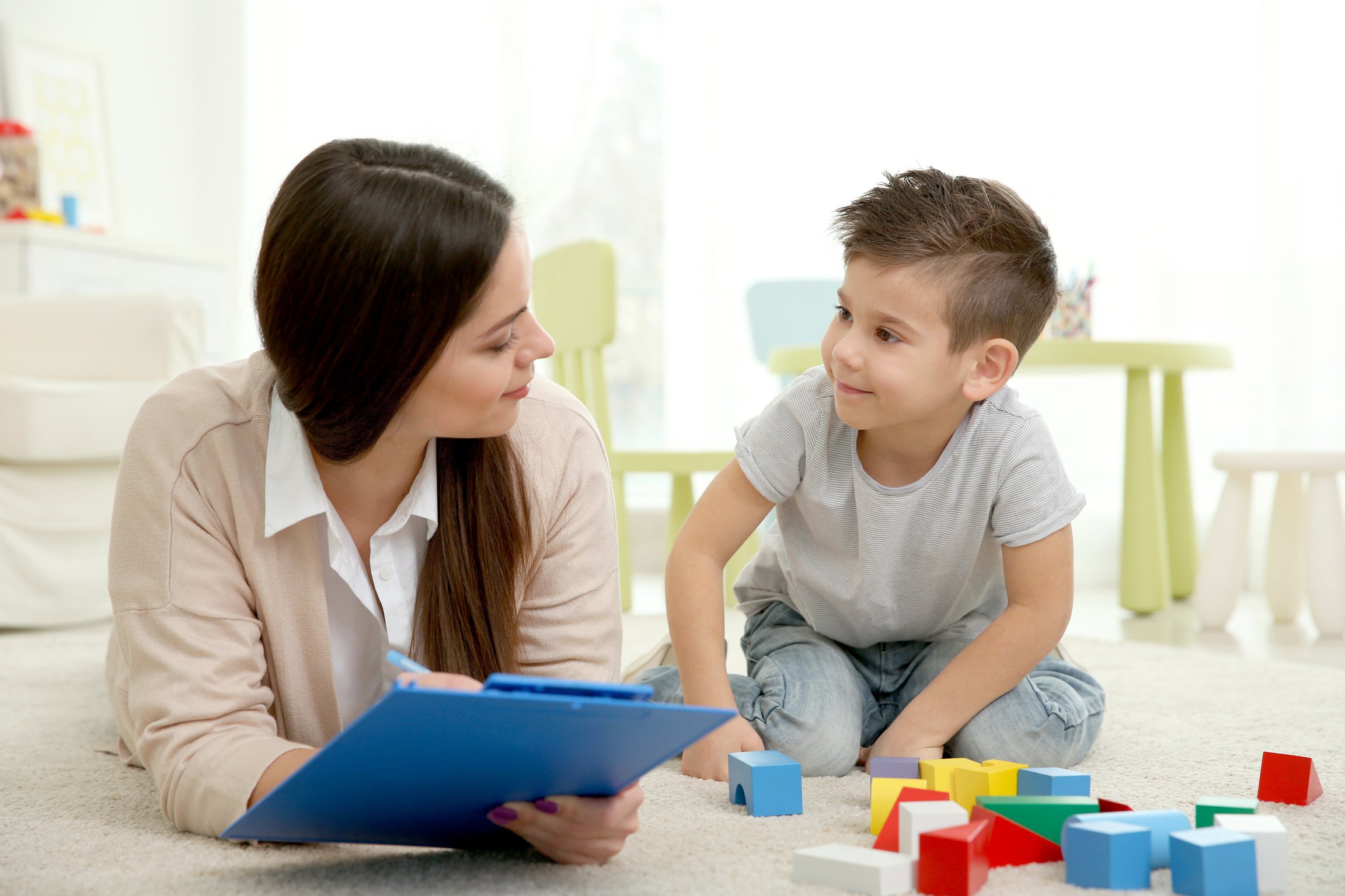 Young Child Psychologist Working with Little Boy